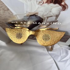 Schiaparelli glasses aesthetic surrealist style exaggerated heavy industry glasses