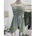 Sleeveless top with strapless folds waist cinching and slit design
