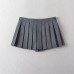 Short skirt with bottom pants and bow tie at waist