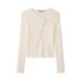 Asymmetric buckle knitted jacket on the street